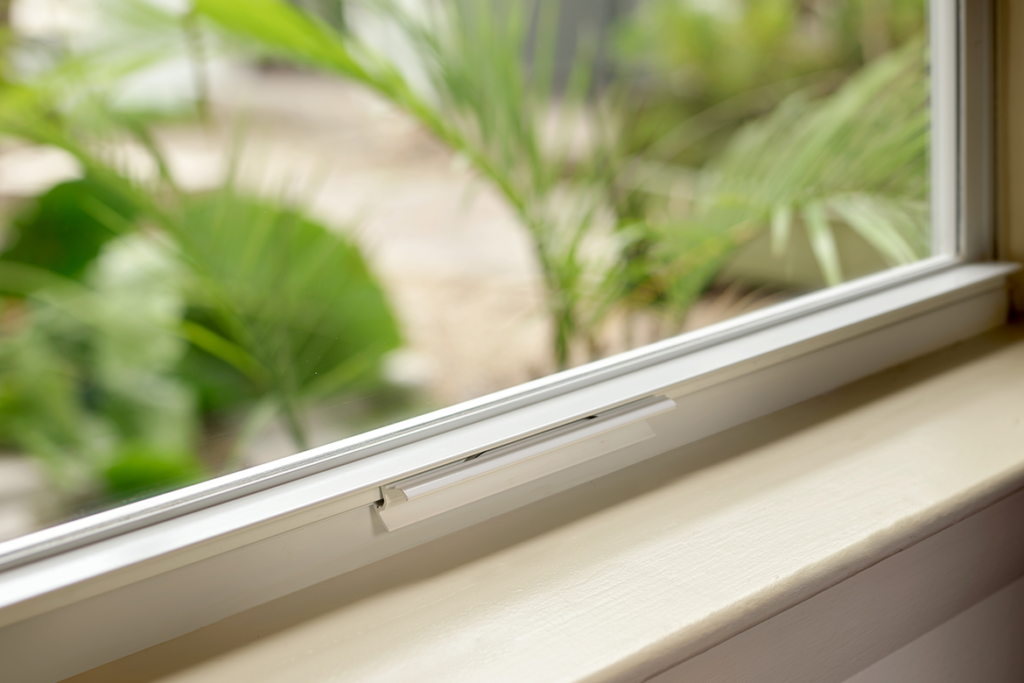 Beautiful aluminum hurricane impact resistant window in a coastal home